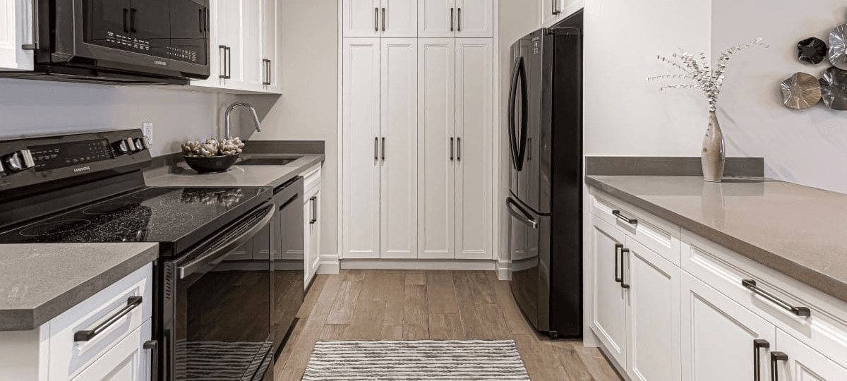 Penthouse kitchen with white cabinetry and full pantry
